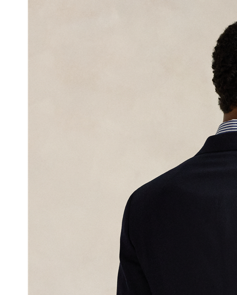 An essential building block of the  Ralph Lauren Lauren look, our iconic Polo blazer is the result of time-honoured traditions spanning decades of impeccable design. Its doeskin wool was custom-developed in collaboration with Italian weavers to achieve a finer, softer, and lighter feel than anything before and finished to reduce shine. The soft shoulder, which harkens to classic American haberdashery, is achieved through meticulous interior tailoring that trims excess fabric and padding, followed by a unique pressing process. Fine canvassing combined with an elegant lapel roll and a lower button stance creates an ideal silhouette that can be worn both formally and casually.
