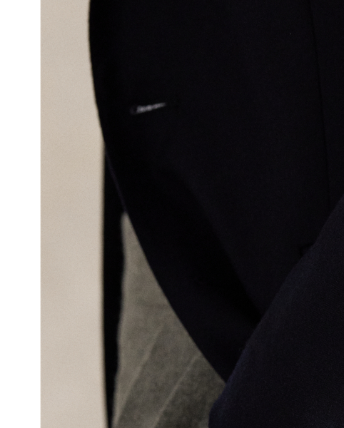 An essential building block of the  Ralph Lauren Lauren look, our iconic Polo blazer is the result of time-honoured traditions spanning decades of impeccable design. Its doeskin wool was custom-developed in collaboration with Italian weavers to achieve a finer, softer, and lighter feel than anything before and finished to reduce shine. The soft shoulder, which harkens to classic American haberdashery, is achieved through meticulous interior tailoring that trims excess fabric and padding, followed by a unique pressing process. Fine canvassing combined with an elegant lapel roll and a lower button stance creates an ideal silhouette that can be worn both formally and casually.