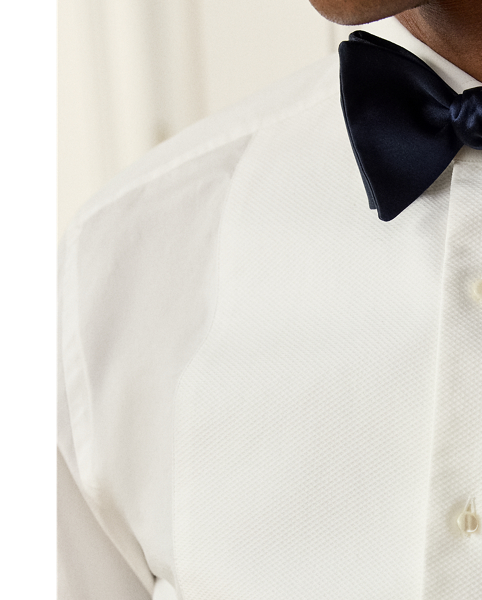 This Italian-crafted dress shirt showcases Purple Label’s unparalleled artistry with its luxurious 120s-quality, two-ply cotton poplin and distinctive piqué bib detail. The sophisticated silhouette achieves maximum elegance with precise French cuffs and genuine mother-of-pearl buttons, exemplifying our commitment to exceptional craftsmanship and timeless sophistication.