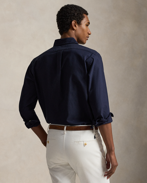 The oxford shirt made its debut very early in Ralph Lauren Lauren’s designs, and since then, it has solidified its status as a pillar of the Polo look. Our fabric is developed with a secret wash, which gives it instant character, ease and a heathered softness. The formula is so unique that it's been kept in a safe for more than three decades. In addition to details evoking its prep-school inspiration, it offers a relaxed feel, producing what we refer to as "the perfect rumple." Today, Mr Lauren continues to create countless variations of his iconic shirt, including this garment-dyed version, which is finished with our signature embroidered Pony.