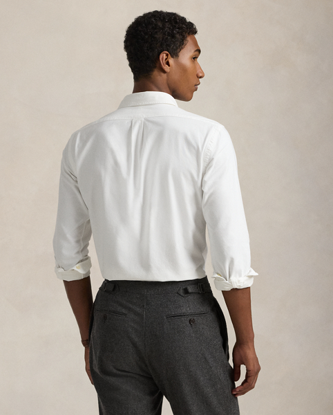 The oxford shirt made its debut very early in Ralph Lauren Lauren’s designs, and since then, it has solidified its status as a pillar of the Polo look. Our fabric is developed with a secret wash, which gives it instant character, ease and a heathered softness. The formula is so unique that it's been kept in a safe for more than three decades. In addition to details evoking its prep-school inspiration, it offers a relaxed feel, producing what we refer to as "the perfect rumple." Today, Mr Lauren continues to create countless variations of his iconic shirt, including this garment-dyed version, which is finished with our signature embroidered Pony.