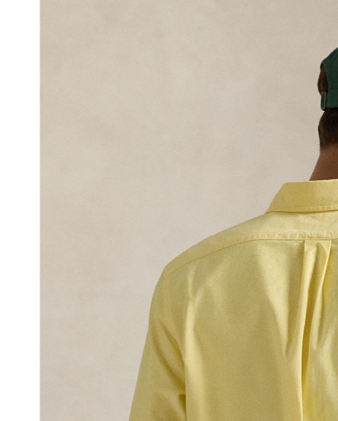 The oxford shirt made its debut very early in  Ralph Lauren Lauren’s designs, and since then, it has solidified its status as a pillar of the Polo look. Our fabric is developed with a secret wash, giving it instant character, ease and a heathered softness – what we refer to as "the perfect rumple". The formula is so unique that it's been kept in a safe for more than three decades. Today, Mr Lauren continues to create countless variations of his iconic shirt, including this Custom Fit version, which is embroidered with our multicoloured signature Pony.