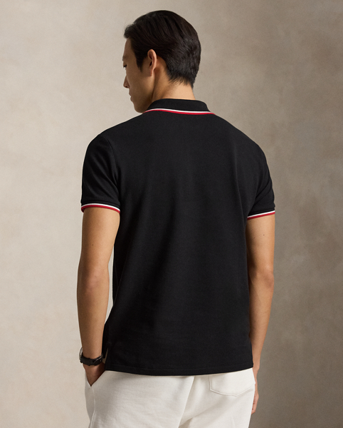 An American style standard since 1972, the Polo shirt has been imitated but never matched. Over the decades, Ralph Lauren Lauren has re-imagined his signature style in a wide array of colours and fits, yet all retain the quality and attention to detail of the iconic original. This trim version is made from our highly breathable cotton mesh, which offers a textured look and a soft feel.
