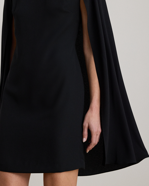 A stylish choice for special occasions, this modern georgette cocktail dress is elevated by a cascading cape, which adds fluid movement to its body-hugging silhouette.