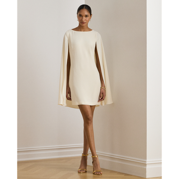 A stylish choice for special occasions, this modern georgette cocktail dress is elevated by a cascading cape, which adds fluid movement to its body-hugging silhouette.