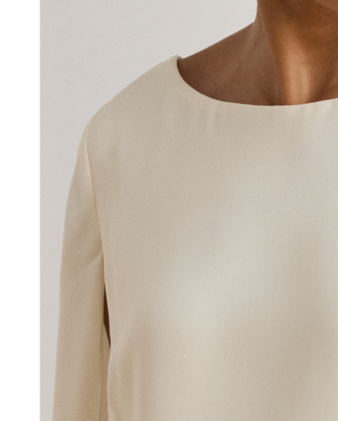 A stylish choice for special occasions, this modern georgette cocktail dress is elevated by a cascading cape, which adds fluid movement to its body-hugging silhouette.