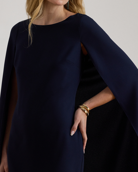 A stylish choice for special occasions, this modern georgette cocktail dress is elevated by a cascading cape, which adds fluid movement to its body-hugging silhouette.