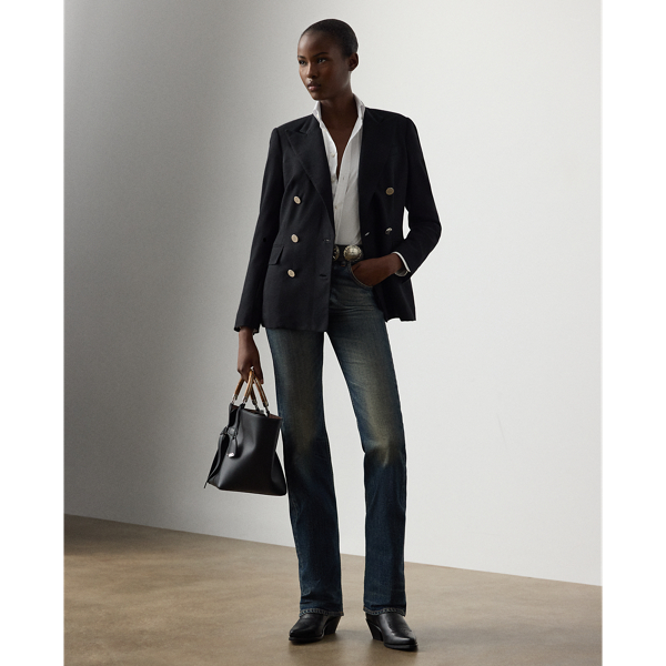 Designed with a high rise and a relaxed bootcut silhouette, the Kaida jean draws inspiration from the traditional cowboy denim trouser, one of the earliest examples of technical sportswear. Cut from stretch cotton denim with a tinted medium stone wash indigo and detailed with subtle abrasions for a worn-in look, this Italian-made pair is finished with a leather tab on the coin pocket and a leather patch on the back, each adorned with antiqued brass studs.