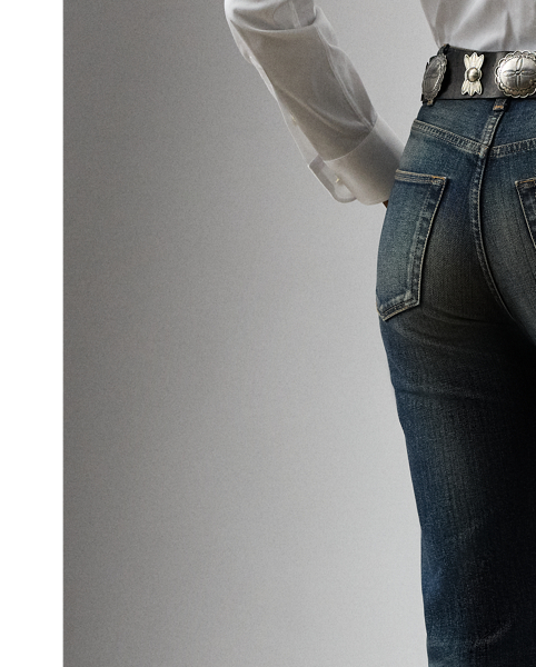 Designed with a high rise and a relaxed bootcut silhouette, the Kaida jean draws inspiration from the traditional cowboy denim trouser, one of the earliest examples of technical sportswear. Cut from stretch cotton denim with a tinted medium stone wash indigo and detailed with subtle abrasions for a worn-in look, this Italian-made pair is finished with a leather tab on the coin pocket and a leather patch on the back, each adorned with antiqued brass studs.