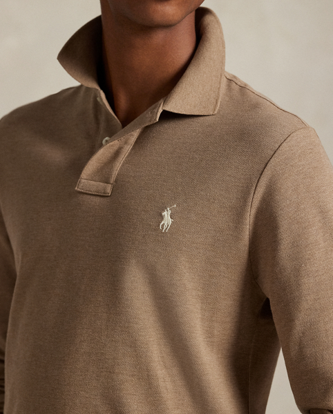 An American style standard since 1972, the Polo shirt has been imitated but never matched. Over the decades, Ralph Lauren Lauren has re-imagined his signature style in a wide array of colours and fits, yet all retain the quality and attention to detail of the iconic original. This trim version is made from our highly breathable cotton mesh, which offers a textured look and a soft feel.