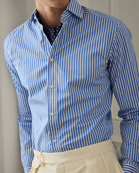 This shirt is masterfully tailored in Italy with lightweight cotton poplin and detailed with genuine mother-of-pearl buttons. It features a bengal-stripe pattern with a saturated blue colour, both of which were custom-developed for Ralph Lauren Lauren.
