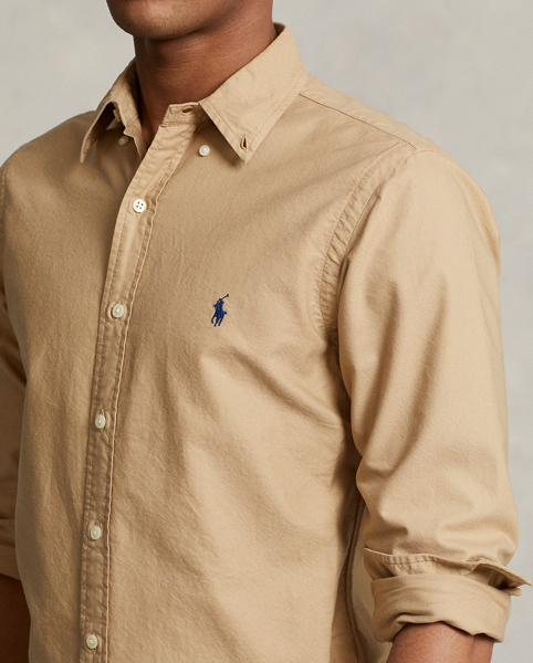 The oxford shirt made its debut very early in Ralph Lauren Lauren’s designs, and since then, it has solidified its status as a pillar of the Polo look. Our fabric is developed with a secret wash, which gives it instant character, ease and a heathered softness. The formula is so unique that it's been kept in a safe for more than three decades. In addition to details evoking its prep-school inspiration, it offers a relaxed feel, producing what we refer to as "the perfect rumple." Today, Mr Lauren continues to create countless variations of his iconic shirt, including this garment-dyed version, which is finished with our signature embroidered Pony.