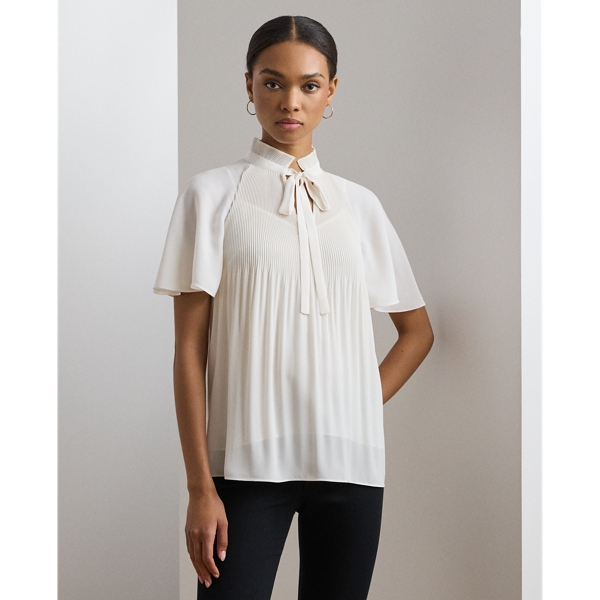Cut for a breezy, relaxed silhouette, this blouse is defined by flutter sleeves and delicate sunray pleating. Crafted with semi-sheer georgette, it comes with a camisole lining for opacity.