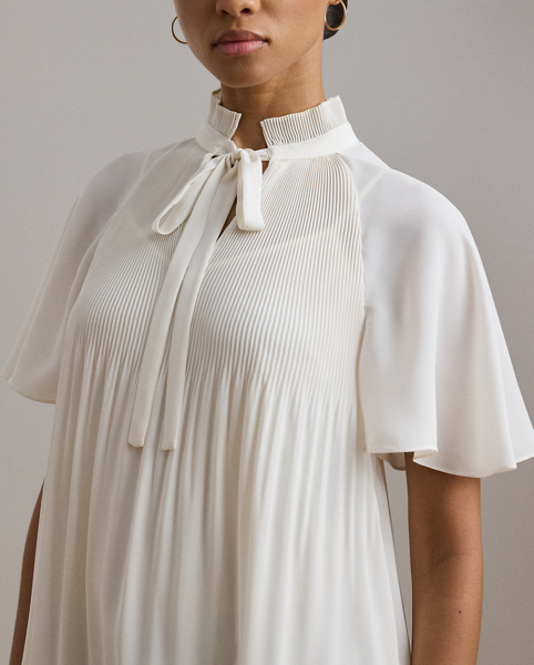 Cut for a breezy, relaxed silhouette, this blouse is defined by flutter sleeves and delicate sunray pleating. Crafted with semi-sheer georgette, it comes with a camisole lining for opacity.