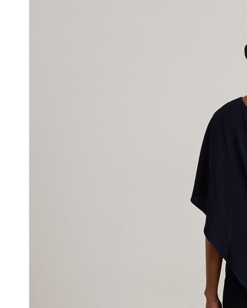 An elegant choice for your next occasion, this statuesque one-shoulder jumpsuit is defined by a cascading cape. Its luxurious georgette fabrication creates fluid movement with each step.