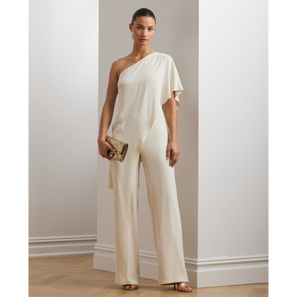 An elegant choice for your next occasion, this statuesque one-shoulder jumpsuit is defined by a cascading cape. Its luxurious georgette fabrication creates fluid movement with each step.