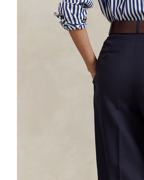 A pleated front construction and tonal silk faille side stripes define the tuxedo-inspired style of these wide-leg wool trousers.