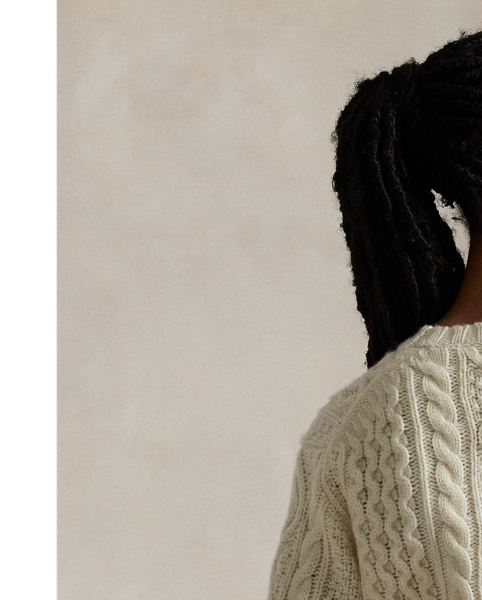 Crafted with chunky Italian yarn that's spun with an alpaca-and-wool blend, this crewneck jumper is designed for a soft hand to complement the raised texture of its classic Aran-knit pattern.