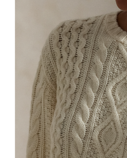 Crafted with chunky Italian yarn that's spun with an alpaca-and-wool blend, this crewneck jumper is designed for a soft hand to complement the raised texture of its classic Aran-knit pattern.