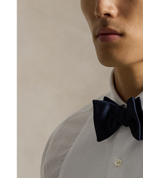 This tuxedo shirt is crafted from lightweight cotton poplin and distinguished by a contrasting double-faced bib on the front. French cuffs and genuine mother-of-pearl buttons complete this sophisticated style.