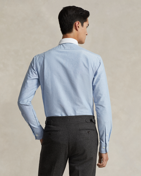 In our signature oxford cloth, this shirt achieves a polished Polo look with its contrasting club collar and genuine mother-of-pearl buttons.