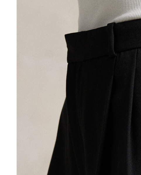 A pleated front construction and tonal silk faille side stripes define the tuxedo-inspired style of these wide-leg wool trousers.