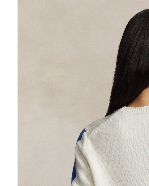 Prominently featuring an oversized crest intarsia-knit at the centre-front, this wool crewneck jumper is inspired by  Ralph Lauren Lauren's celebrated winter collections from the late 1980s and early 1990s. The crest features the now-iconic "Downhill Skier" graphic – a silhouette of a skier barrelling down a steep run – that originally debuted on small shield patches at the chest of  Ralph Lauren Lauren's jackets, long-sleeve Polo shirts and socks in 1989.