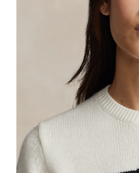 Prominently featuring an oversized crest intarsia-knit at the centre-front, this wool crewneck jumper is inspired by  Ralph Lauren Lauren's celebrated winter collections from the late 1980s and early 1990s. The crest features the now-iconic "Downhill Skier" graphic – a silhouette of a skier barrelling down a steep run – that originally debuted on small shield patches at the chest of  Ralph Lauren Lauren's jackets, long-sleeve Polo shirts and socks in 1989.