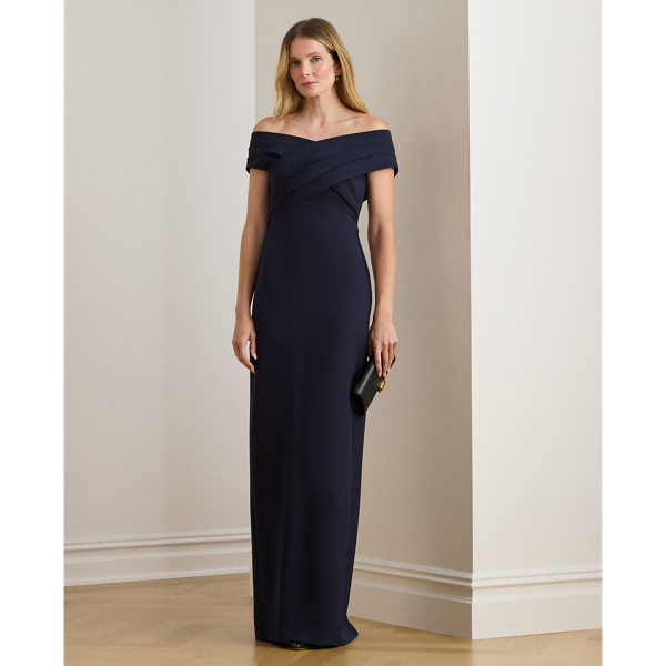 Designed with an overlapping off-the-shoulder neckline for a style that is equal parts alluring and sophisticated, this statuesque gown is crafted with smooth, delicate crepe for a body-hugging fit.