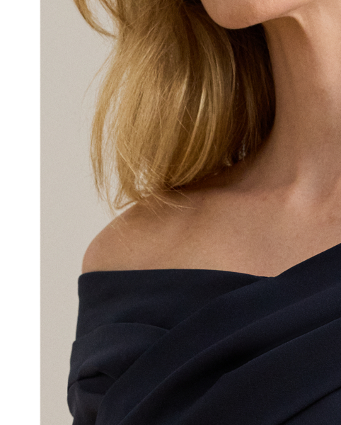 Designed with an overlapping off-the-shoulder neckline for a style that is equal parts alluring and sophisticated, this statuesque gown is crafted with smooth, delicate crepe for a body-hugging fit.