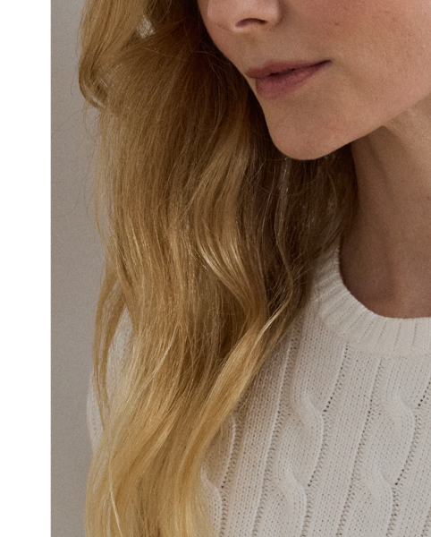 Lauren  Ralph Lauren Lauren updates the classic cable-knit jumper with signature button embellishments on the shoulder and an "LRL"-embroidered logo on the chest. Cut for a slim-fitting silhouette, it's knit from combed cotton for a soft hand.