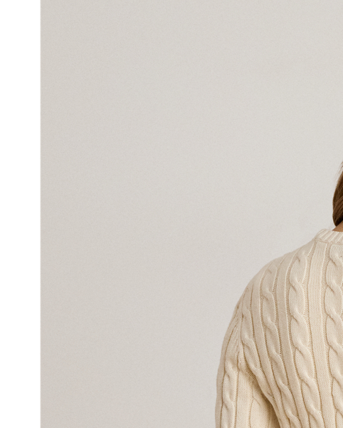 Crafted with gassed cotton for an amazingly soft feel, this classic cable-knit cardigan is accented with "LRL"-engraved buttons and Lauren's signature embroidered logo on the chest for an iconic Lauren  Ralph Lauren Lauren layering piece.