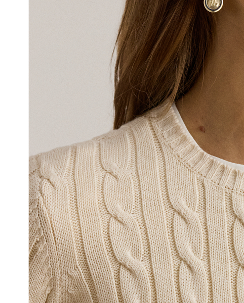 Crafted with gassed cotton for an amazingly soft feel, this classic cable-knit cardigan is accented with "LRL"-engraved buttons and Lauren's signature embroidered logo on the chest for an iconic Lauren  Ralph Lauren Lauren layering piece.