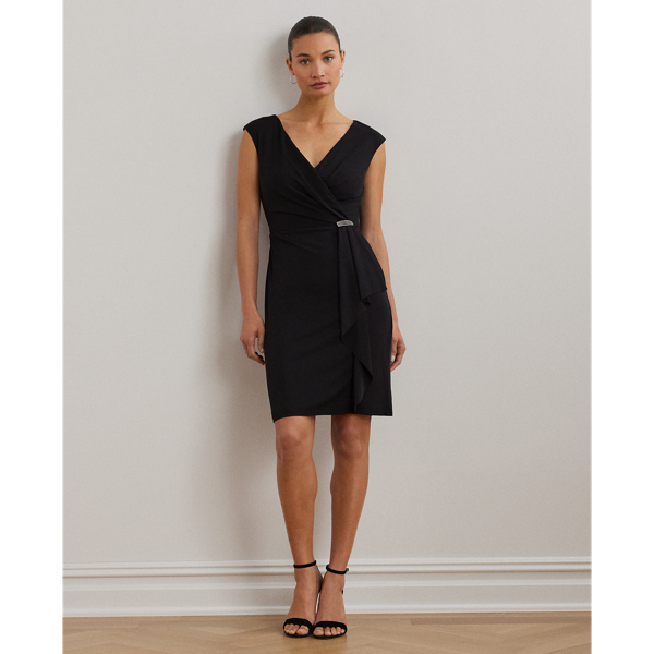 Crafted with fluid jersey, this cocktail dress is designed with cap sleeves and delicate ruching on the bodice that gathers on the waist into a glistening, rhinestone-embellished pin. A cascading ruffle runs down the skirt for an elegant finish.