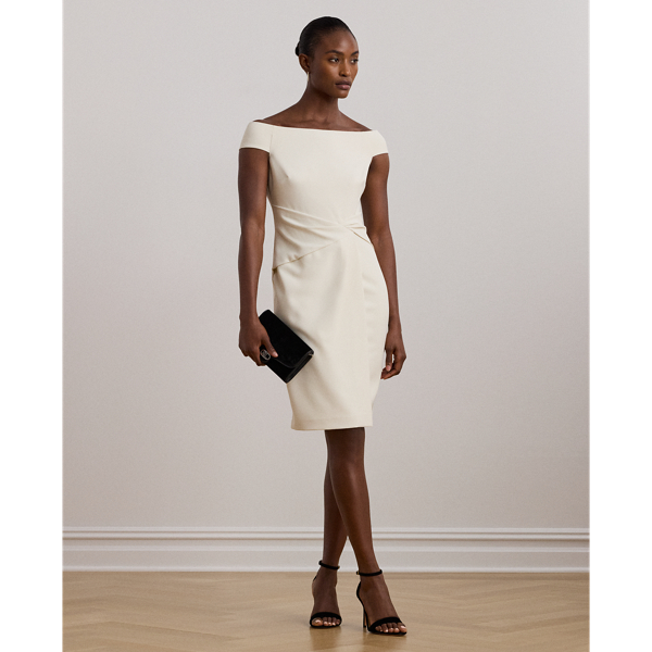 Crafted with smooth crepe for a fluid drape and a luxurious sensibility, this cocktail dress is designed with an elegant off-the-shoulder silhouette and a chic twist detail on the waist. A slit in the skirt creates ease of movement.
