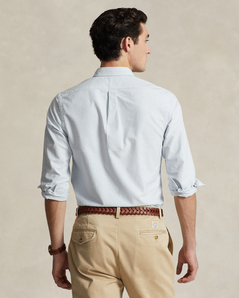 The oxford shirt made its debut very early in Ralph Lauren Lauren’s designs, and since then, it has solidified its status as a pillar of the Polo look. Our fabric is developed with a secret wash, which gives it instant character, ease and a heathered softness. The formula is so unique that it's been kept in a safe for more than three decades. In addition to details evoking its prep-school inspiration, it offers a relaxed feel, producing what we refer to as "the perfect rumple." Today, Mr Lauren continues to create countless variations of his iconic shirt, including this trim version, which is embroidered with our multicoloured signature Pony.