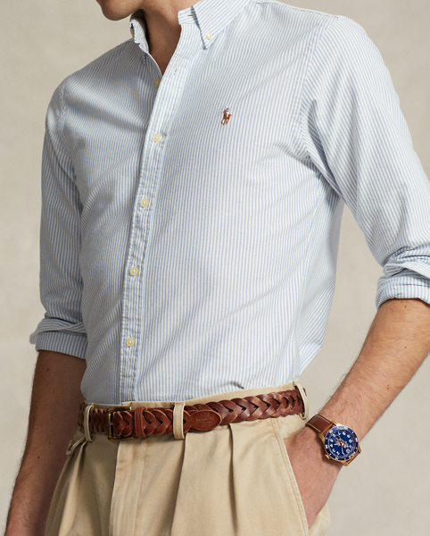 The oxford shirt made its debut very early in Ralph Lauren Lauren’s designs, and since then, it has solidified its status as a pillar of the Polo look. Our fabric is developed with a secret wash, which gives it instant character, ease and a heathered softness. The formula is so unique that it's been kept in a safe for more than three decades. In addition to details evoking its prep-school inspiration, it offers a relaxed feel, producing what we refer to as "the perfect rumple." Today, Mr Lauren continues to create countless variations of his iconic shirt, including this trim version, which is embroidered with our multicoloured signature Pony.