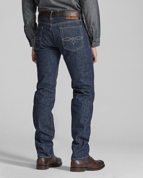 Straight-fitting jeans made in America from 13.75 oz. selvedge denim that is shuttle-woven in Japan. Cotton yarns are ring-spun and rope-dyed to achieve Double RL's deepest indigo shade with an authentic red-blue cast. Right-hand twill is custom-developed to create a "grin-through" effect in which the lighter-hued weft yarns are visible on the face of the cloth. Rinsed and specially treated for a soft, sun-dried effect. Sanforized to minimise shrinkage.