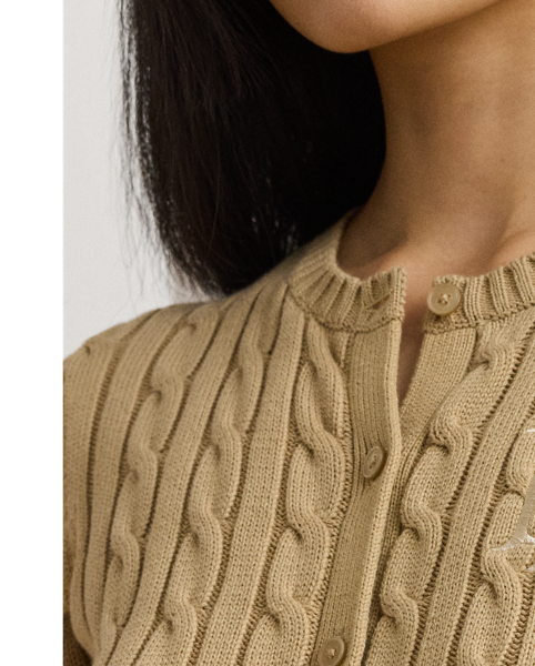 Crafted with gassed cotton for an amazingly soft feel, this classic cable-knit cardigan is accented with "LRL"-engraved buttons and Lauren's signature embroidered logo on the chest for an iconic Lauren  Ralph Lauren Lauren layering piece.