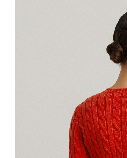 Crafted with gassed cotton for an amazingly soft feel, this classic cable-knit cardigan is accented with "LRL"-engraved buttons and Lauren's signature embroidered logo on the chest for an iconic Lauren  Ralph Lauren Lauren layering piece.