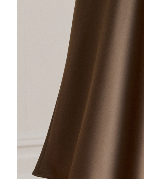 A staple piece that can be easily dressed up or down, this midi skirt is rendered in silky satin charmeuse for a fluid drape and subtle sheen.