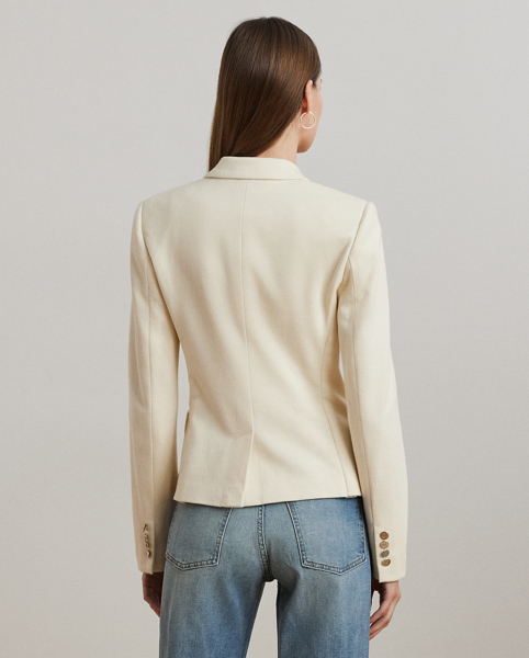 Crafted with a soft, stretch-infused cotton jacquard fabric, this sophisticated blazer is defined by a double-breasted silhouette and peak lapels. A bullion patch at the chest adds signature style, while waist darts and panel seams afford a tailored finish.