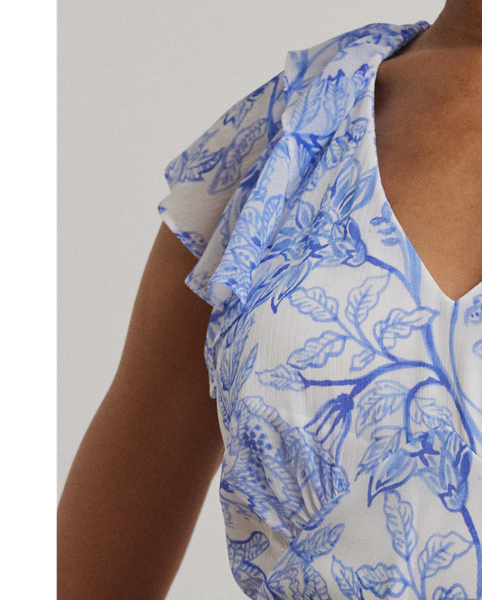 Crinkle georgette and a ruffle-trimmed tiered skirt bring effortless movement to this belted flutter-sleeve dress, which displays a blue and white floral motif rendered in the style of an ink sketch.