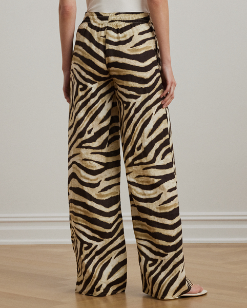 Crafted with airy linen for maximum comfort, these wide-leg drawcord trousers are refreshed with the season's eye-catching zebra print.