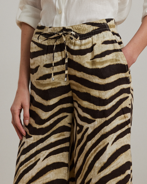 Crafted with airy linen for maximum comfort, these wide-leg drawcord trousers are refreshed with the season's eye-catching zebra print.