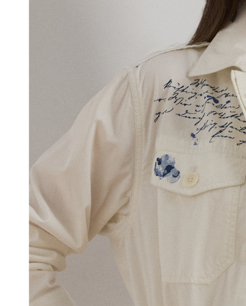 Crafted with featherweight cotton twill, this field jacket features a myriad of patch pockets, a drawcord waist, buttoned shoulder epaulets and a travel-inspired, abstract stamp motif.