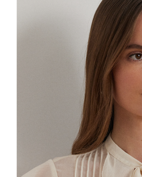 Airy, semi-sheer georgette beautifully complements this blouse's relaxed silhouette, ruffle-trimmed V-neck and flutter-sleeve design. Detailed with pintucks at the bodice, this style comes with a camisole lining for opacity.