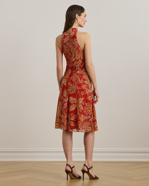 Featuring a bamboo-inspired metal embellishment at the neckline, this enchanting halter dress is crafted from crinkle georgette printed with the season's painterly floral motif.