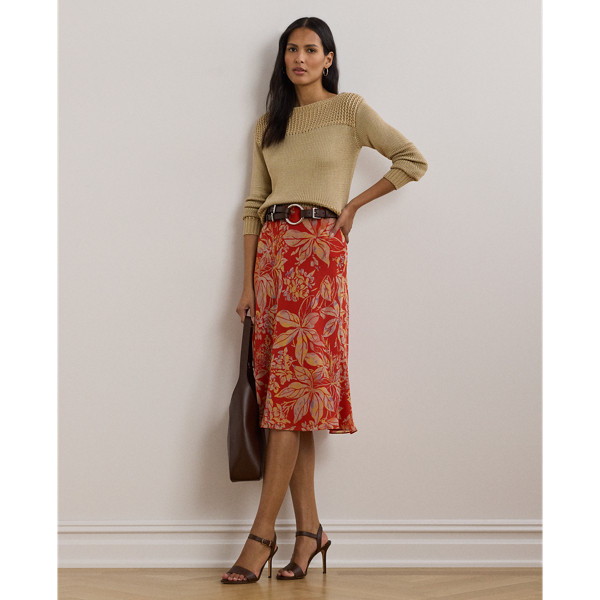 Crafted from airy crinkle georgette, this A-line midi skirt displays a painterly floral motif against a vibrant red backdrop.