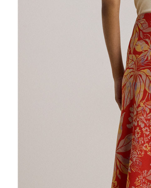 Crafted from airy crinkle georgette, this A-line midi skirt displays a painterly floral motif against a vibrant red backdrop.